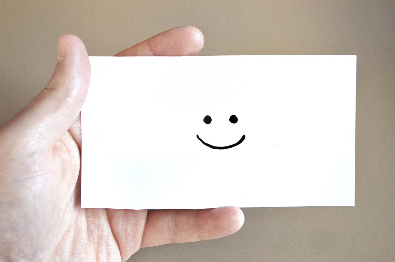 a stock photo of a notecard with a smiley face on it, copyright free to use